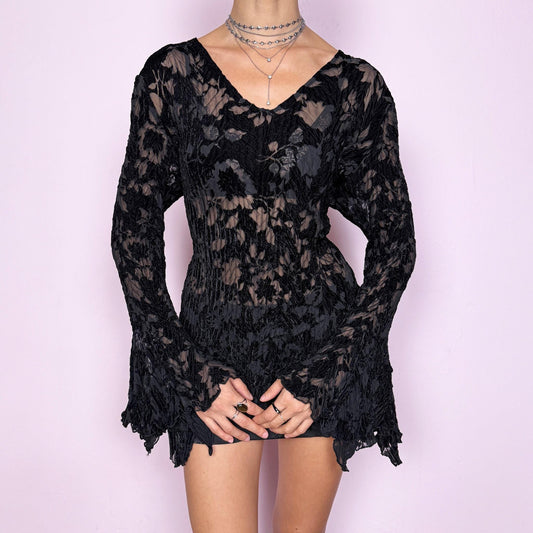 This vintage 2000s top features a dramatic black velvet devoré burnout design with sheer floral detailing, styled with asymmetric bell sleeves, a fitted silhouette, and an asymmetric flared hem. The piece delivers a dark romantic, goth, witchy aesthetic ideal for formal glam parties, festivals, and avant-garde evening wear. A rare archival French design blouse made from a stretchy devoré velvet blend. Excellent vintage condition.