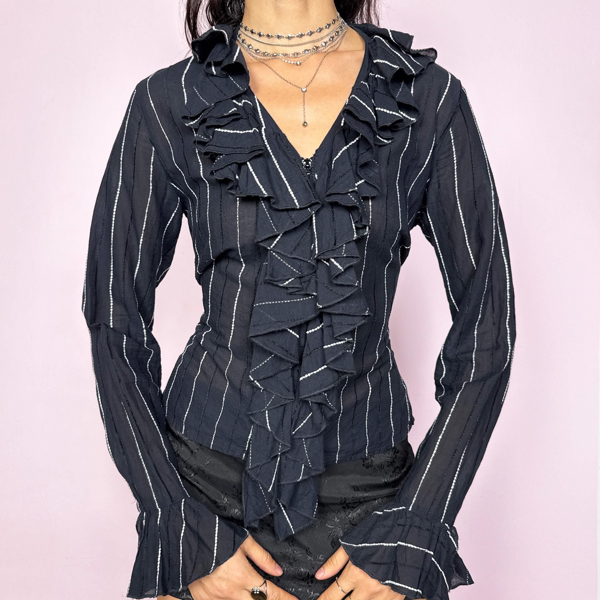 Avant-garde vintage 2000s dark navy blue (almost black) pinstripe blouse featuring a ruffled neckline and cuffs, front zip closure, and adjustable lace-up back for a perfectly tailored fit. The structured silhouette combines romantic detailing with formal edge, ideal for elegant office looks and evening dinners. Made from cotton and polyamide blend. Great vintage condition.