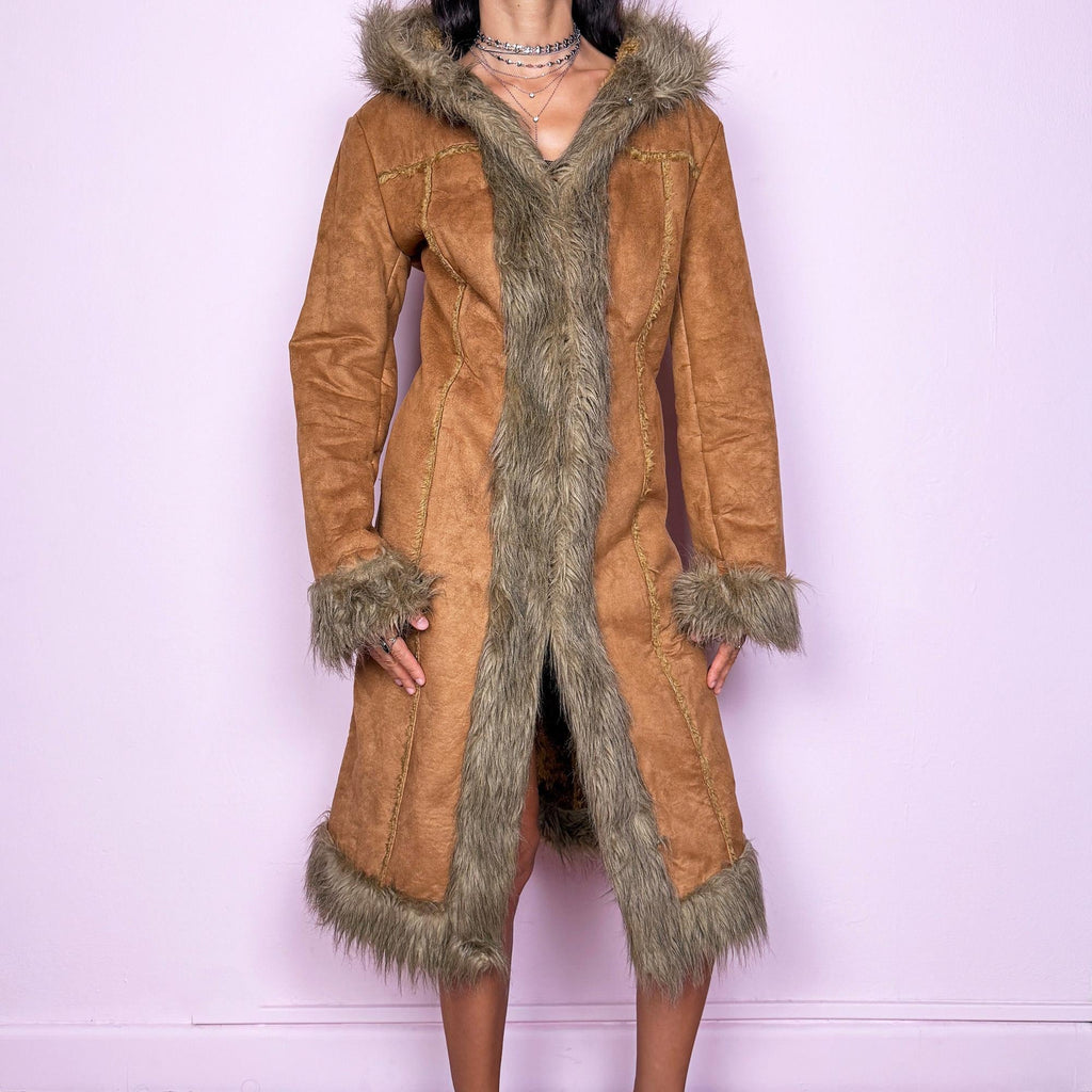 This vintage 2000s brown faux suede long coat features a hooded Afghan Penny Lane silhouette with plush beige faux fur trim and cuffs. Fitted through the body with hidden hook closure and side pockets, it delivers a warm, bohemian look perfect for autumn and winter layering. Made from faux suede with faux fur lining. Great vintage condition.