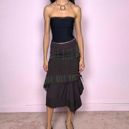 Vintage 2000s dark brown asymmetric midi skirt with an avant garde deconstructed layered design, featuring striped panels with subtle green lines, lace trim, and tie drawstring side details. Side zipper closure with no stretch. Fairy grunge aesthetic. Can be worn high waisted for size S or worn lower on the waist for size XS/XXS. Made by a French brand from a cotton polyester polyamide blend. Great vintage condition.