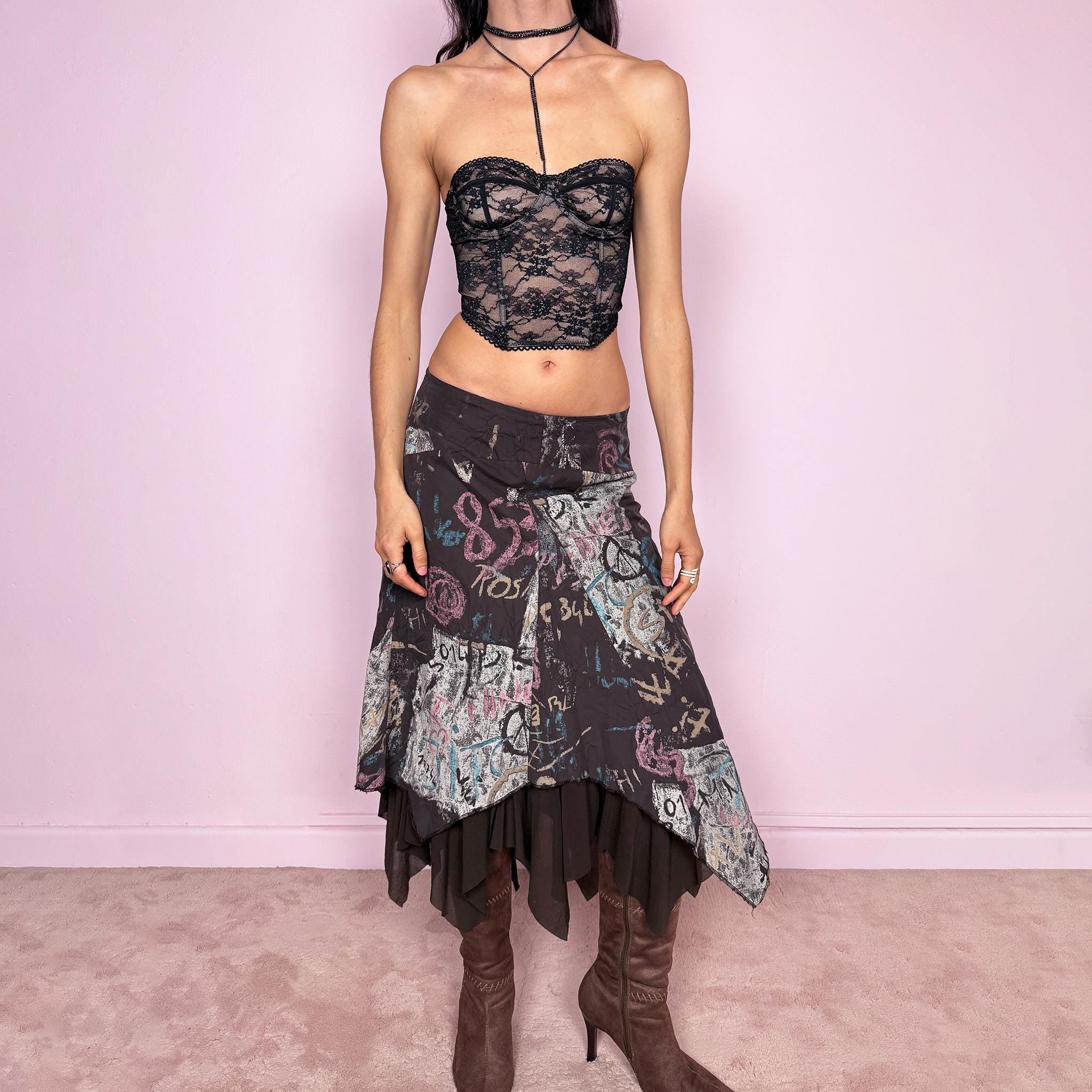 Vintage 2000s brown deconstructed avant garde skirt with a layered asymmetric hem and sheer mesh underlayer. Features a fluid draped silhouette with graphic print and side zip closure, no stretch. Can be worn high rise for size M or mid to low rise for XS/S. Made in France by a French brand from polyamide. Excellent vintage condition.