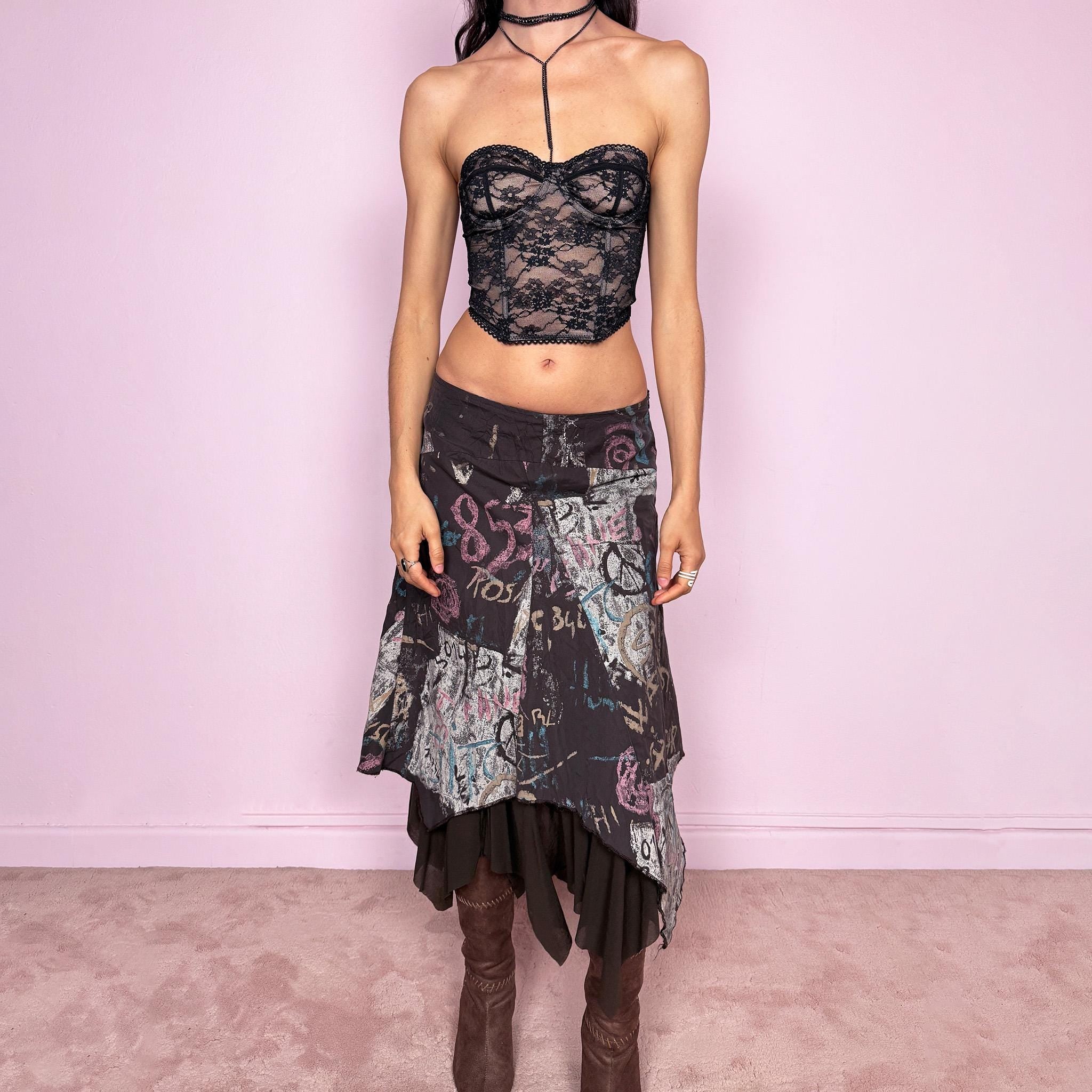Vintage 2000s brown deconstructed avant garde skirt with a layered asymmetric hem and sheer mesh underlayer. Features a fluid draped silhouette with graphic print and side zip closure, no stretch. Can be worn high rise for size M or mid to low rise for XS/S. Made in France by a French brand from polyamide. Excellent vintage condition.