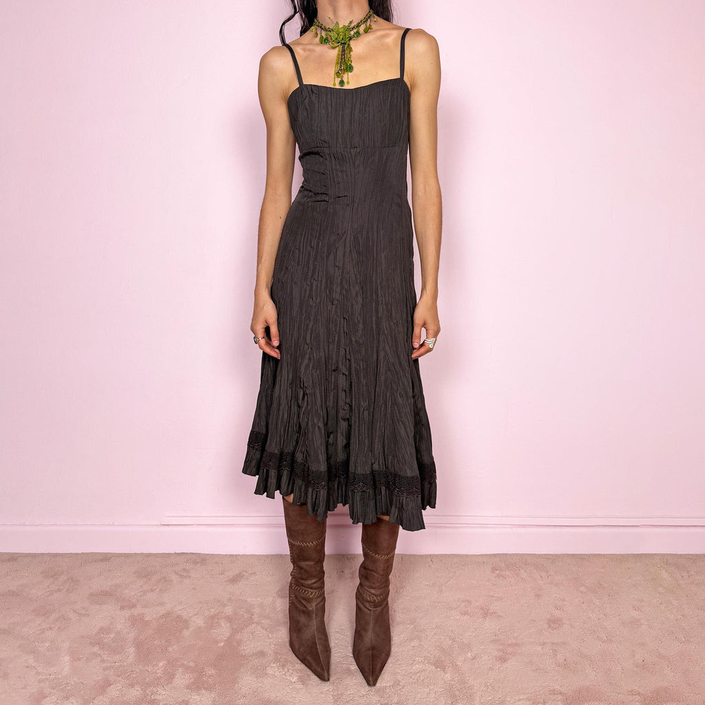 Vintage 2000s dark brown midi dress with a crinkle pleated texture and sleek fitted silhouette. Features adjustable straps, side zip closure, and a soft ruffle hem for fluid movement. Non-stretch design with minimal avant-garde elegance, perfect for formal parties, night events, or dark fairy styling. Excellent vintage condition.