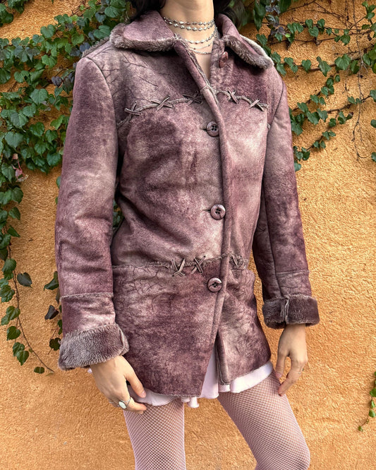 Vintage 2000s faux shearling coat in a rare reddish-brown (terracotta) tie-dye distressed finish. Features a faux fur collar and cuffs, button closure, side pockets, and decorative criss-cross stitch detailing for a dystopic cyber-grunge aesthetic. The straight silhouette makes it ideal for winter layering and festival styling. A standout 2000s piece for streetwear, weird-girl outfits, and bold cold-weather looks. Made from a polyester acrylic blend. Great vintage condition.