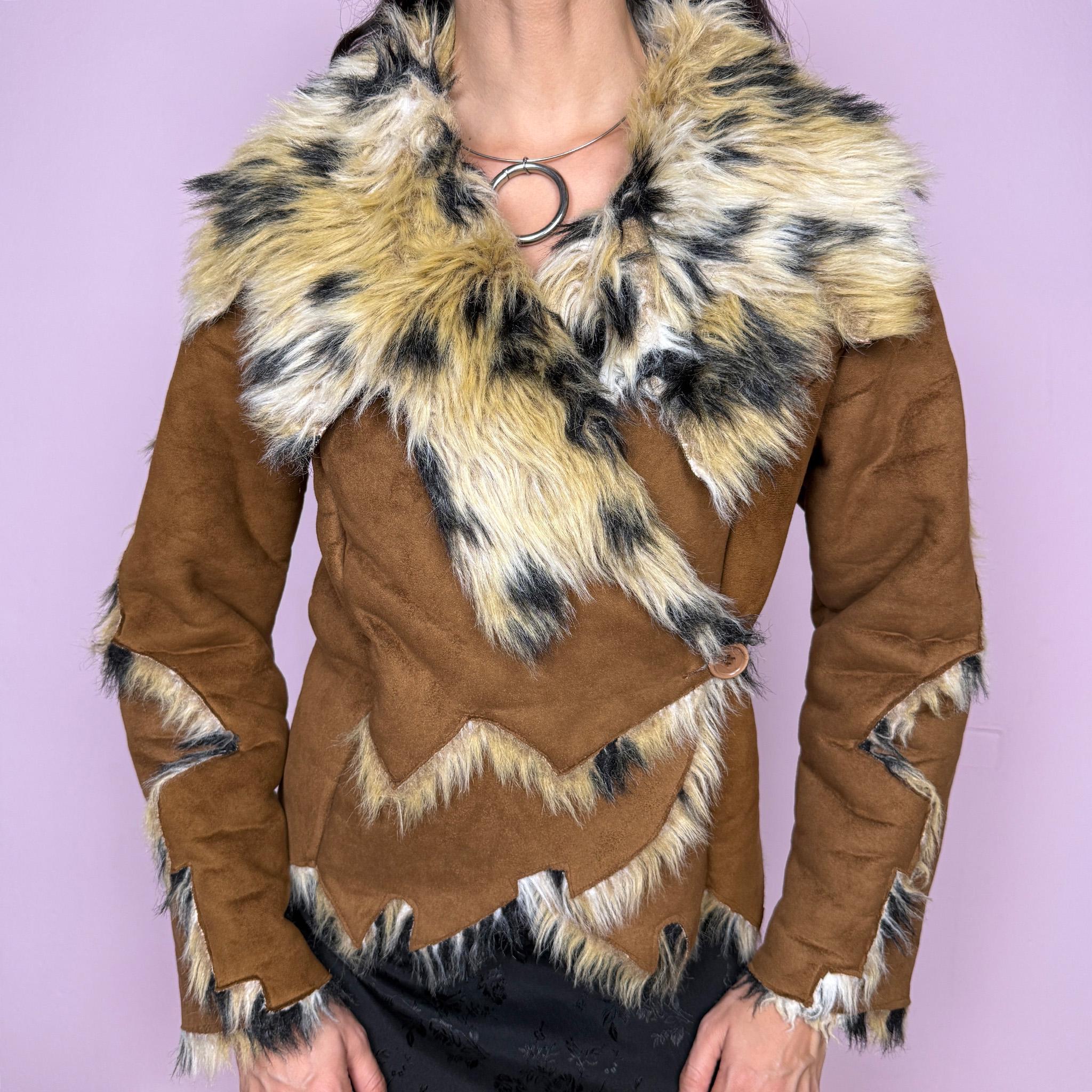 Bold statement vintage 2000s Penny Lane jacket with a brown faux suede exterior and beige and black faux fur interior and collar with an animal print–inspired look. Eye-catching unique design with a fitted silhouette, two-button closure, pockets, and an asymmetric hem. Made from polyester by a European brand. Excellent vintage condition.
