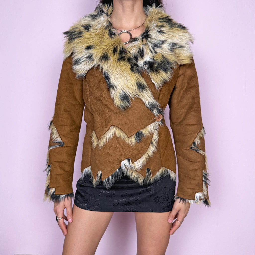 Bold statement vintage 2000s Penny Lane jacket with a brown faux suede exterior and beige and black faux fur interior and collar with an animal print–inspired look. Eye-catching unique design with a fitted silhouette, two-button closure, pockets, and an asymmetric hem. Made from polyester by a European brand. Excellent vintage condition.