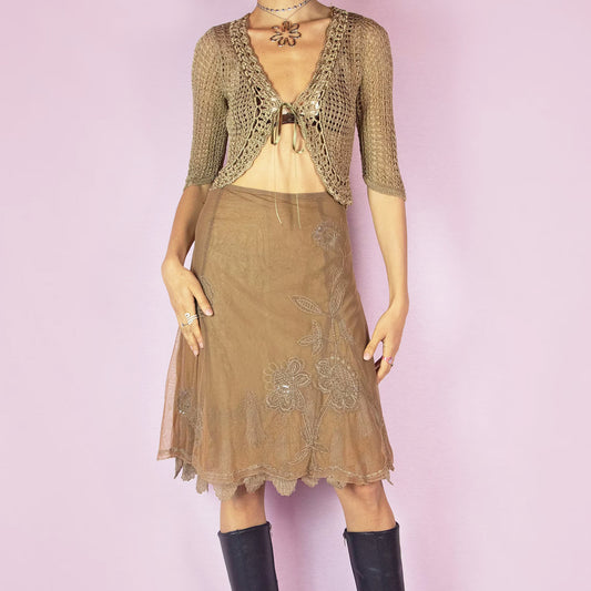 This vintage 2000s brown mesh skirt blends elegant romance with soft evening drama. Features floral embroidery embellished with sequins and beads, a trumpet-style godet silhouette, and sheer overlay with scalloped hem. Cut in a mid-length with a side zipper closure. The layered mesh and flared shape create graceful movement. Perfect for parties, dinners, or romantic looks with earthy sophistication.
