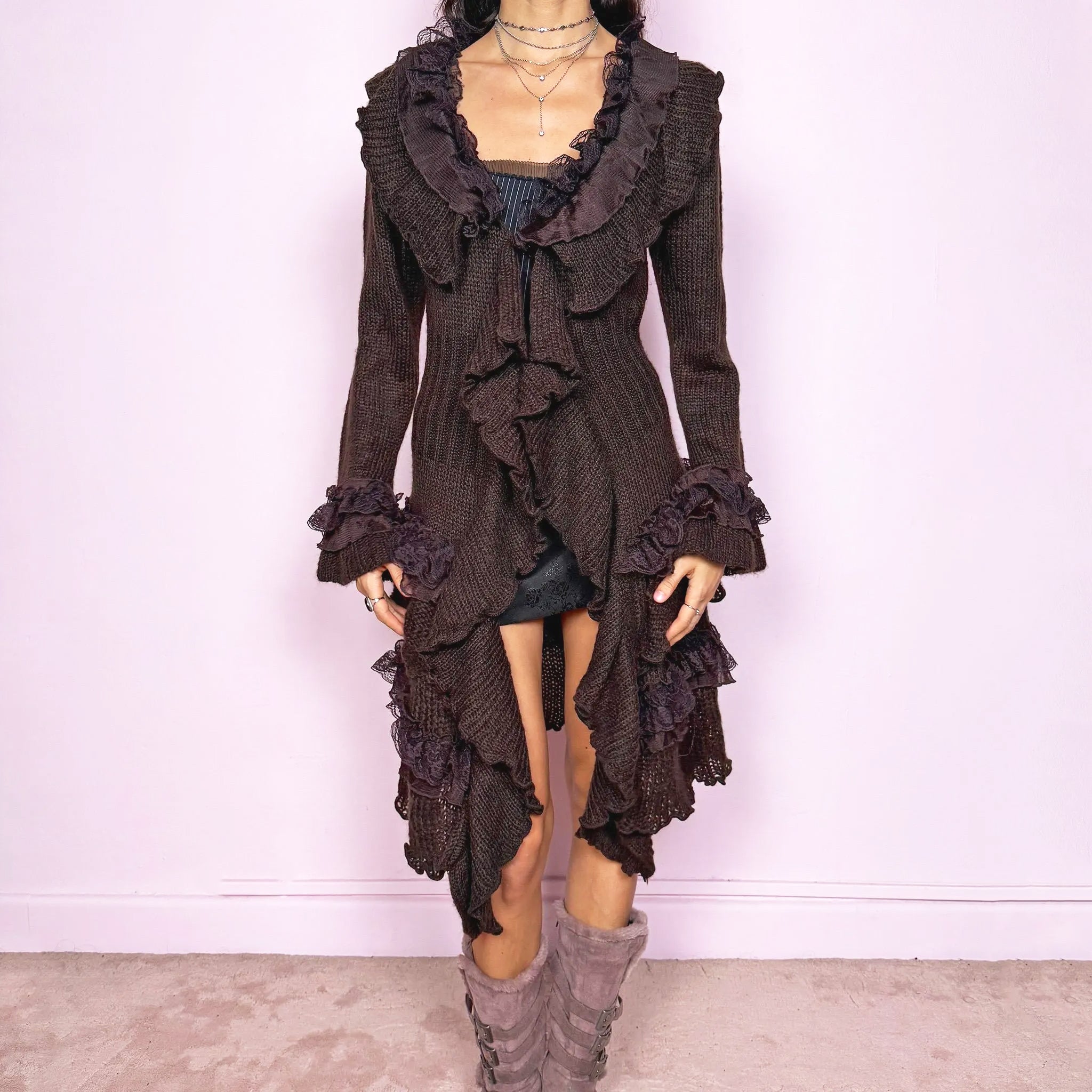 Vintage 2000s romantic dark brown longline cardigan with dramatic ruffle neckline and lace details. Features bell sleeves with ruffle cuffs, toggle front closure and an asymmetric pointy hem. Whimsical fairycore silhouette with dark baroque rococo energy, perfect for cozy winter layering. Made from a 35% mohair and 45% acrylic blend. Excellent vintage condition.