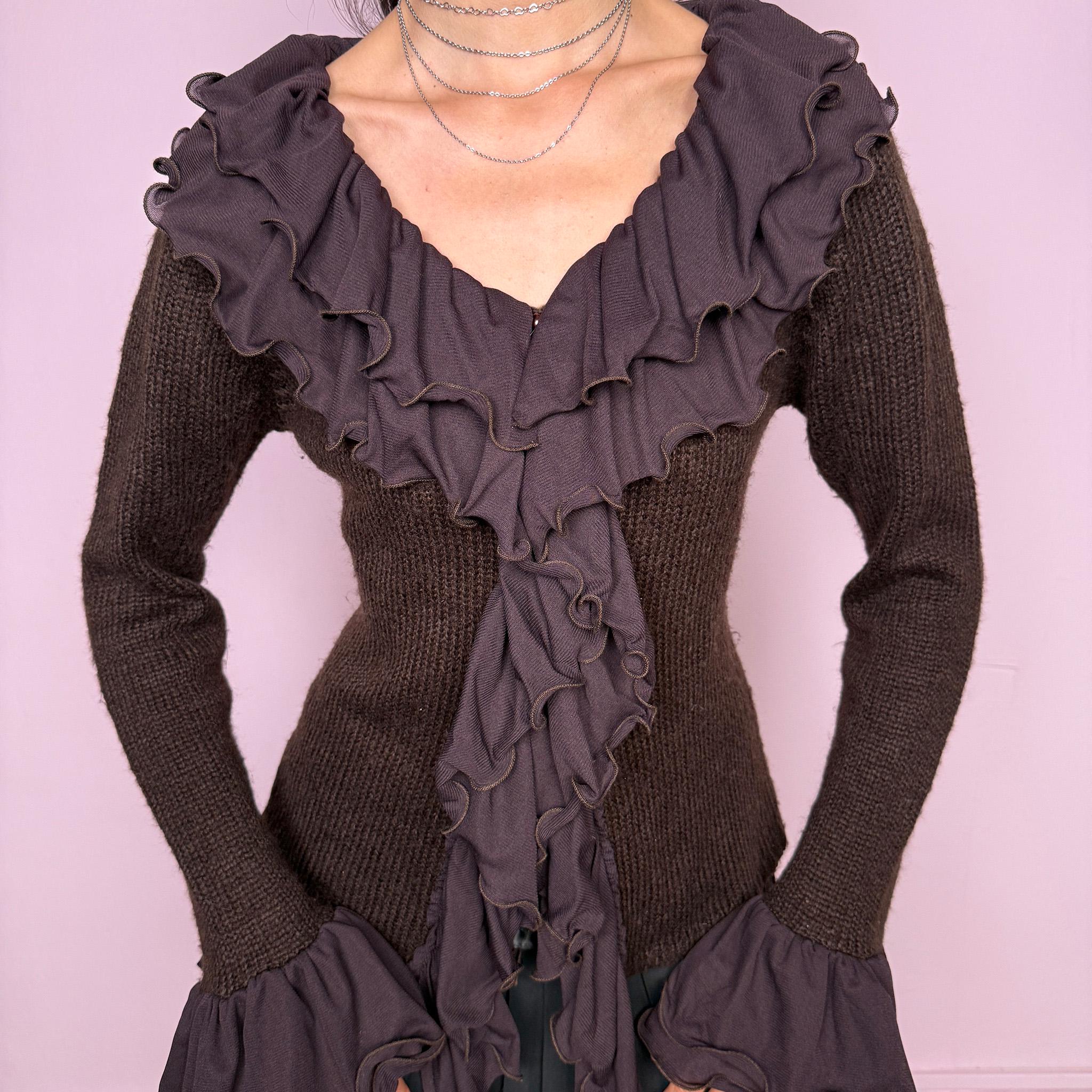 Vintage 2000s dark brown cardigan made from a stretchy knit, featuring dramatic layered mesh ruffles, delicate front buttons, and flared ruffle cuffs. A feminine dark fairy Y2K piece with a romantic statement silhouette. Made from 35% wool, 10% cashmere, and 55% acrylic. Great vintage condition.
