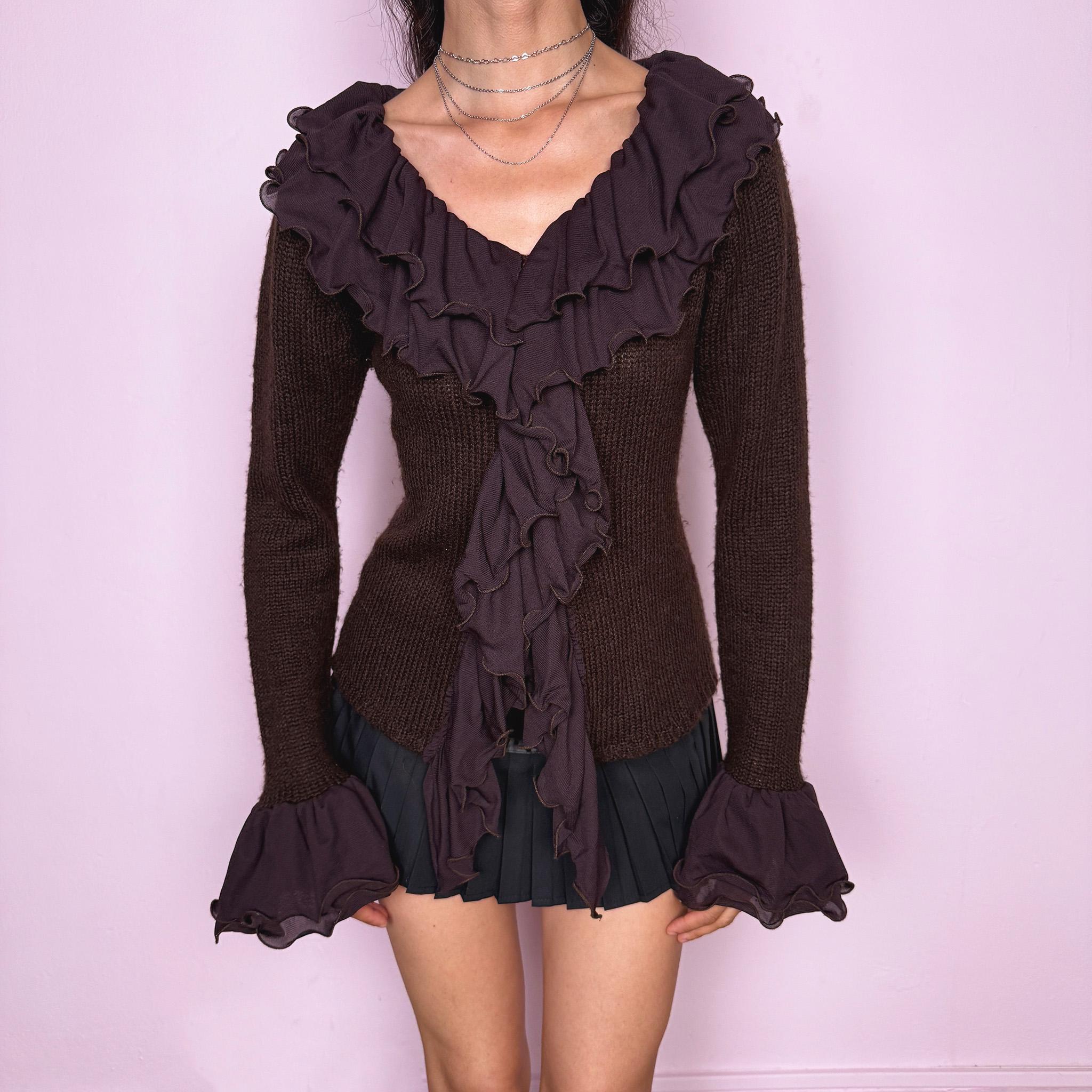 Vintage 2000s dark brown cardigan made from a stretchy knit, featuring dramatic layered mesh ruffles, delicate front buttons, and flared ruffle cuffs. A feminine dark fairy Y2K piece with a romantic statement silhouette. Made from 35% wool, 10% cashmere, and 55% acrylic. Great vintage condition.