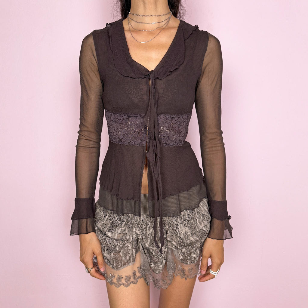 Vintage 2000s delicate brown semi-sheer top featuring long transparent mesh sleeves with ruffle cuffs, lace panels, a stretchy fit, a tiny front hook closure, and a tie-front detail at the neckline. A feminine dark romantic Y2K statement blouse. From a French brand. Excellent vintage condition.