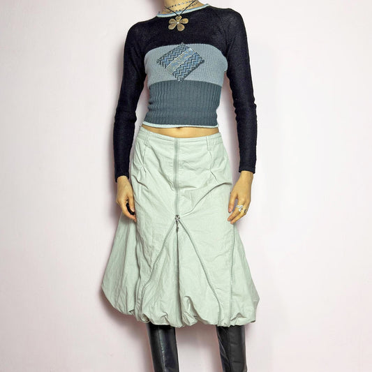 The Y2K Gray Bubble Midi Skirt is a futuristic statement 2000s piece featuring a voluminous bubble silhouette with multiple zipper details that create a dynamic, adjustable shape. Designed with a structured high-rise fit, and a side zipper closure, this skirt is perfect for bold streetwear outfits.