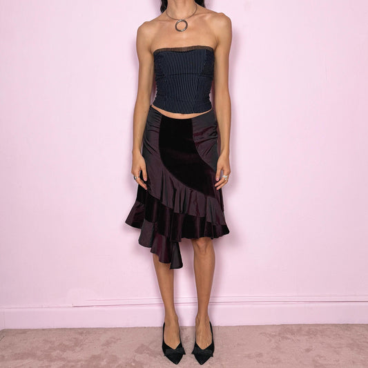 Elegant vintage 2000s burgundy midi skirt with a unique avant-garde design. Features curved velvet paneling, satin panels, and an asymmetric ruffled hem that creates beautiful movement. Side zip closure with slight stretch. Can be worn high waisted for size S or mid rise for size XS. Perfect for formal or party looks. Made in Italy by an Italian brand, 95% cotton. Excellent vintage condition.