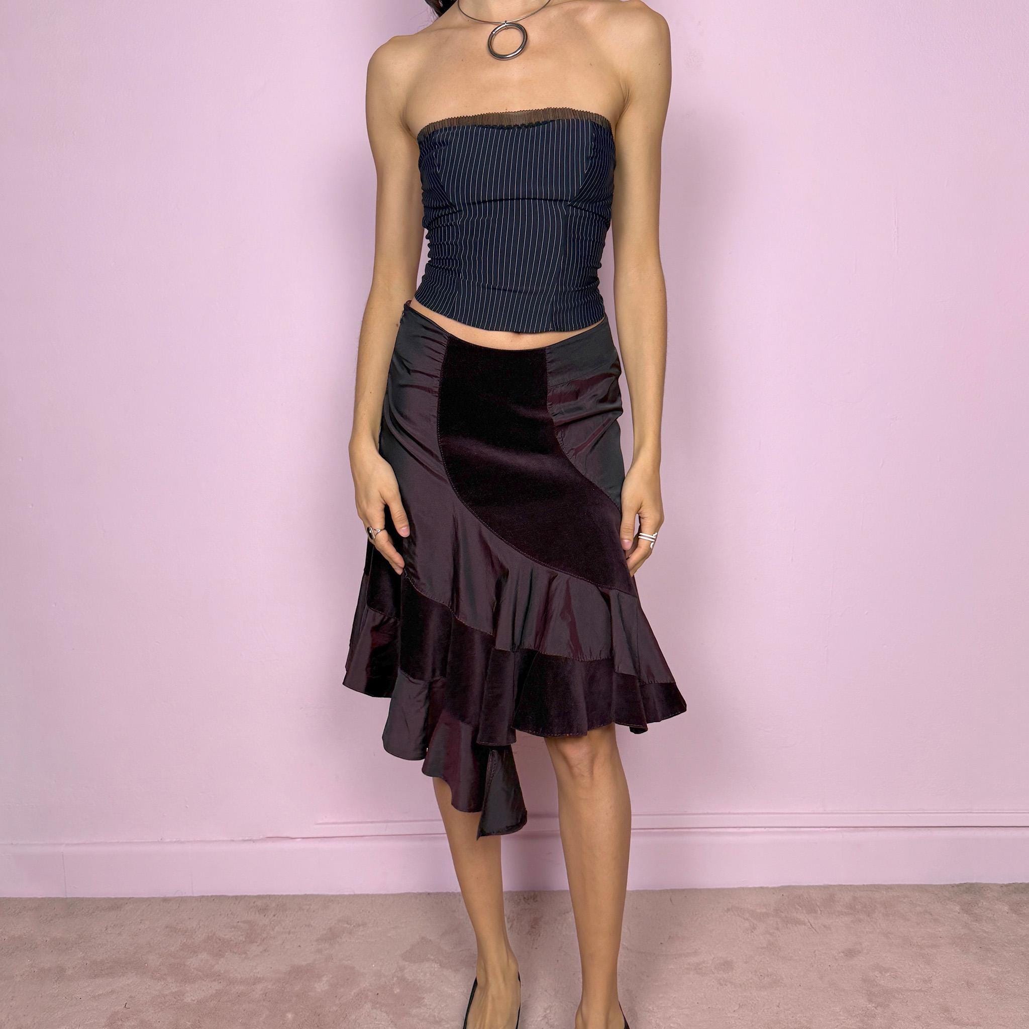 Elegant vintage 2000s burgundy midi skirt with a unique avant-garde design. Features curved velvet paneling, satin panels, and an asymmetric ruffled hem that creates beautiful movement. Side zip closure with slight stretch. Can be worn high waisted for size S or mid rise for size XS. Perfect for formal or party looks. Made in Italy by an Italian brand, 95% cotton. Excellent vintage condition.