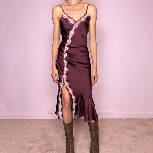 Vintage 2000s burgundy-plum satin-style slip midi dress. Features delicate adjustable straps, a romantic pink lace appliqué trim, asymmetric front detail, high front slit, and a softly flared ruffle hem. Designed in a smooth polyester fabric with no stretch and a feminine body-skimming silhouette. A romantic Y2K evening dress, perfect for dreamy soirées, made in France by a French brand. Excellent vintage condition.