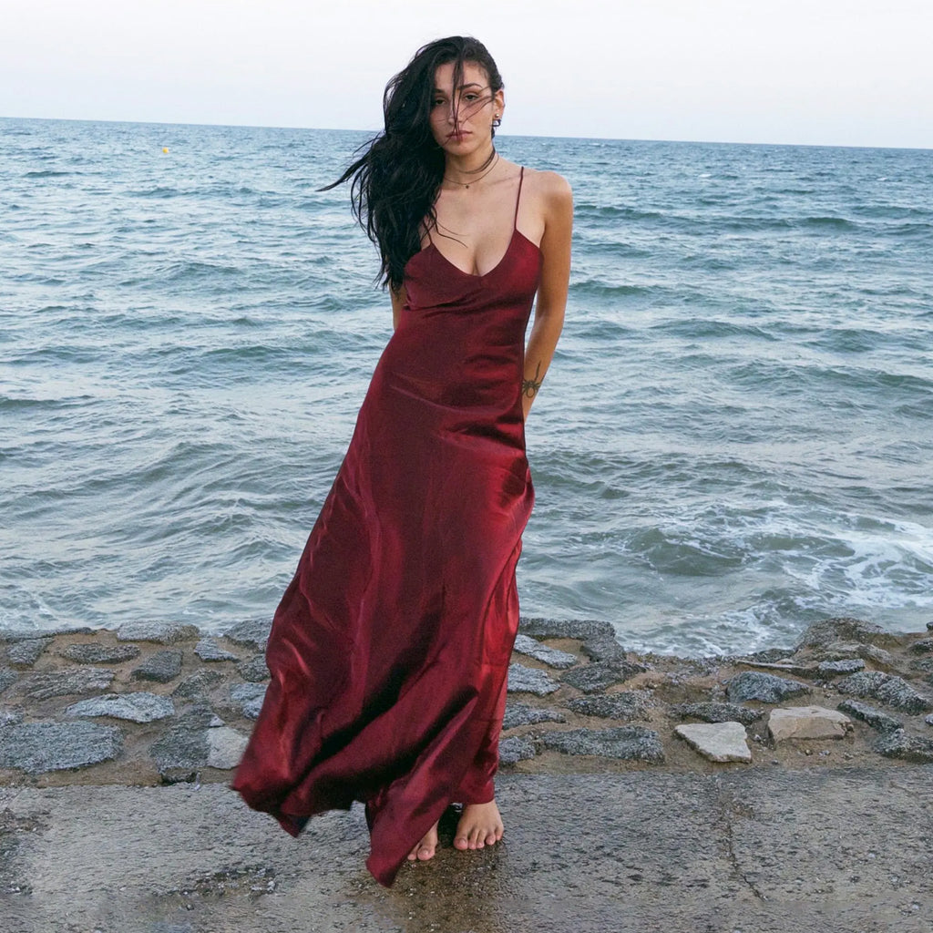 Vintage 2000s burgundy maroon slip dress with a fluid silhouette, spaghetti straps, glossy finish, and body-skimming cut that evokes diva glamour and red carpet allure. Ideal for summer nights, cocktails, or sensual evening entrances. Made by a French brand from a non-stretch polyester blend. Excellent vintage condition.