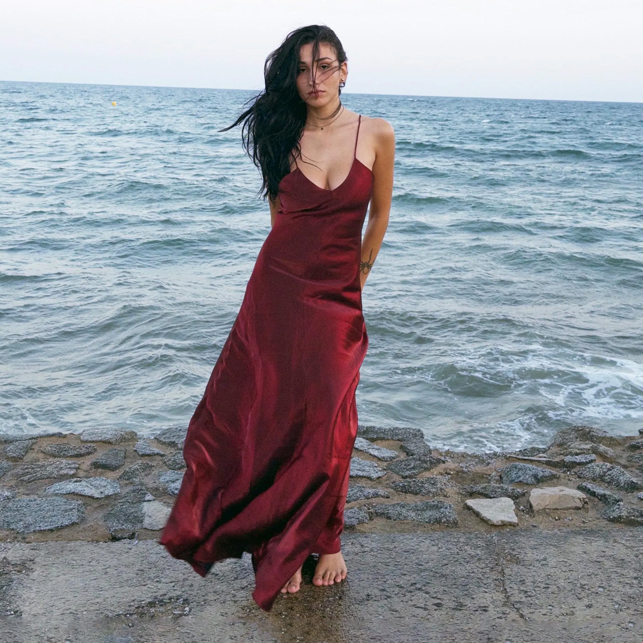 Vintage 2000s burgundy maroon slip dress with a fluid silhouette, spaghetti straps, glossy finish, and body-skimming cut that evokes diva glamour and red carpet allure. Ideal for summer nights, cocktails, or sensual evening entrances. Made by a French brand from a non-stretch polyester blend. Excellent vintage condition.