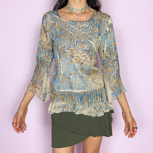 The vintage 2000s bell sleeve top is made in France with a crinkled textured finish. It features an abstract print in soft beige, slate blue, and brown, with a scoop neckline, three-quarter flared sleeves, and a ruffled hem. This blouse blends romantic texture with airy movement—an effortlessly elegant piece for formal avant garde events or earthy, whimsical styling. Made of polyester-spandex blend. Excellent vintage condition.