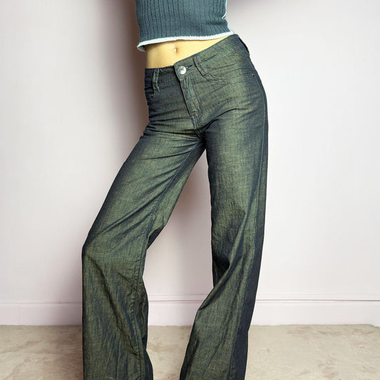 The Y2K Dark Rust Wide Jeans are a vintage 2000s statement piece featuring a structured denim fabric with a unique rust-effect wash, adding a worn-in, vintage appeal. Designed with a high-rise fit, button and zipper closure, and pockets, these jeans have a relaxed wide-leg silhouette that creates an effortlessly cool look. Perfect for edgy streetwear and casual outfits.