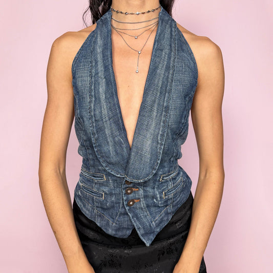 Vintage 2000s statement blue denim backless halter top with adjustable back straps and button closures. Features a deep plunging V neckline, buttoned collared front, and structured no-stretch fit. Party night, office, summer city girl aesthetic. Attributed to Pepe Jeans London with branded engraved buttons. Tag missing. Excellent vintage condition.