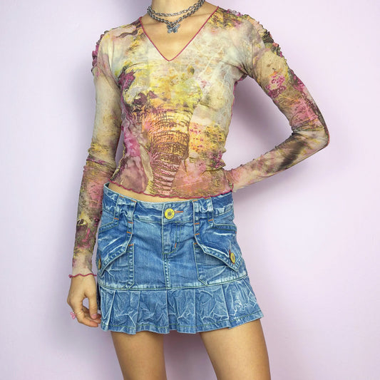 The Y2K Pleated Mini Denim Skirt is a vintage 2000s piece featuring a pleated hem and cargo-style pockets with button details for a playful, utilitarian touch. Crafted from washed blue denim with contrast stitching, this low-rise mini has a button and zipper closure. Perfect for casual, streetwear, or festival looks. Great vintage condition.