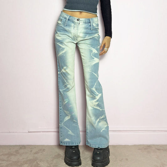 The Y2K Bleached Flare Jeans are a vintage 2000s statement piece featuring a light-wash denim with a bold bleached abstract pattern for a deconstructed, experimental look. Designed with a flattering mid-rise fit, flared legs, button and zipper closure, and pockets, these jeans are a perfect blend of edgy and playful aesthetics. Ideal for standout casual outfits.