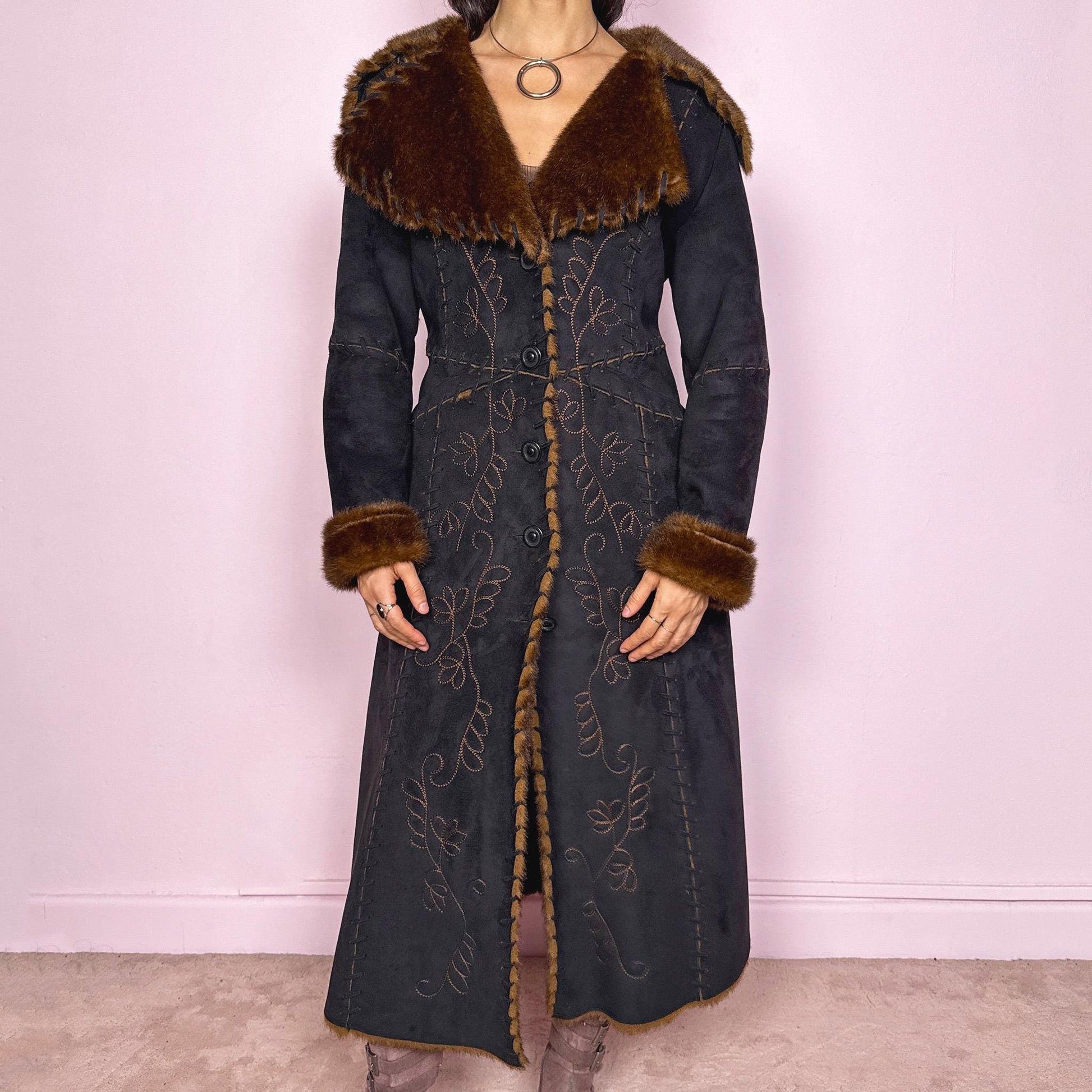 Stunning vintage 2000s dark gray almost black long Penny Lane coat with brown faux fur interior, collar, and cuffs. Features intricate floral embroidery, pockets, and button front closure. Soft faux suede with a warm feel, ideal for whimsical fairycore, boho, forest muse, and 70s Afghan-inspired Y2K styling. French-designed piece. Made from polyester. Excellent vintage condition.