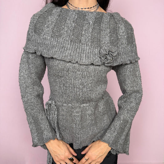 Romantic coquette vintage 2000s gray knit sweater with a folded collar and delicate rosette applique detail. Features flared long sleeves, a tie waist for a cinched silhouette, and a soft stretchy feel. Feminine and cozy, ideal for winter layering or dressed-up Y2K styling. Made from 50% mohair, 40% wool, and 10% spandex. Great vintage condition.