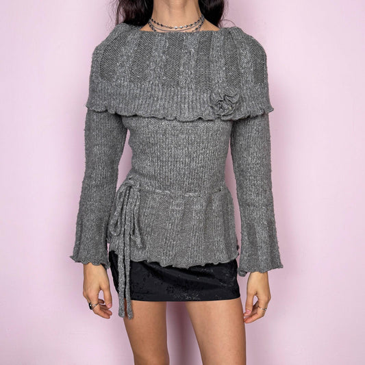 Romantic coquette vintage 2000s gray knit sweater with a folded collar and delicate rosette applique detail. Features flared long sleeves, a tie waist for a cinched silhouette, and a soft stretchy feel. Feminine and cozy, ideal for winter layering or dressed-up Y2K styling. Made from 50% mohair, 40% wool, and 10% spandex. Great vintage condition.