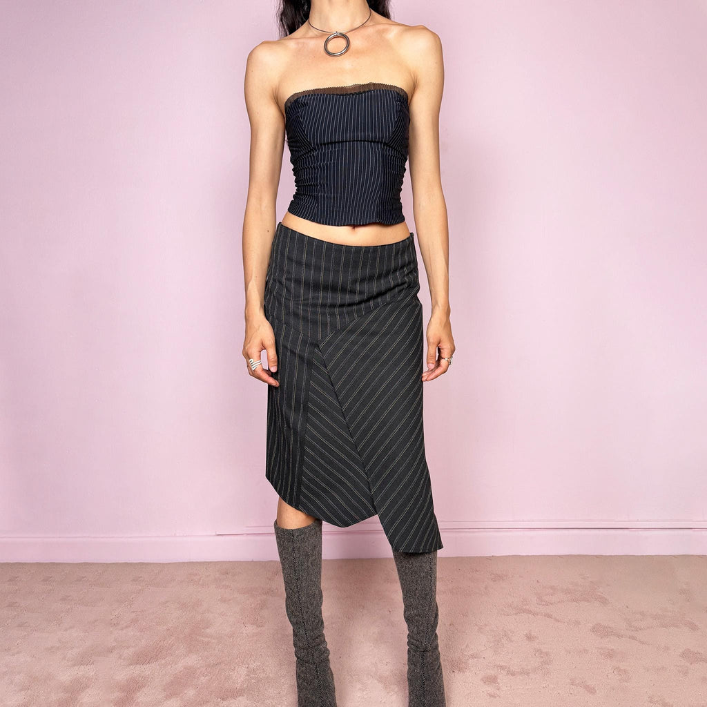 Vintage 2000s dark gray pinstripe midi skirt with a deconstructed avant-garde formal office look. Features an asymmetric layered front, pointed hem, structured no-stretch fit, and side zip closure. Can be worn mid rise for size S or lower rise for size XS. Excellent vintage condition.