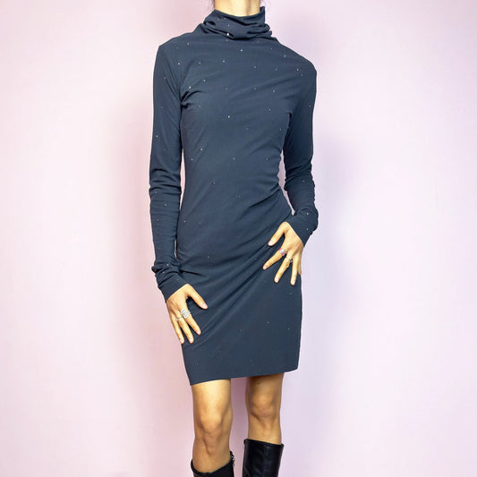 This vintage 2000s grey mini dress is cut from stretchy mesh jersey with an elegant turtleneck and long sleeves. Subtle rhinestones are scattered throughout, catching light with a soft shimmer. The bodycon silhouette hugs the figure with ease. No closure, easy pull-on style. A minimalist Y2K piece with glam undertones—perfect for winter nights, parties, or city outings. Made in Italy. Excellent vintage condition.