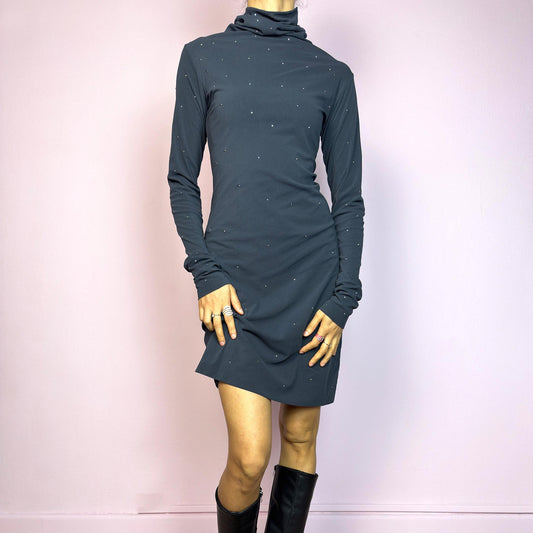 This vintage 2000s grey mini dress is cut from stretchy mesh jersey with an elegant turtleneck and long sleeves. Subtle rhinestones are scattered throughout, catching light with a soft shimmer. The bodycon silhouette hugs the figure with ease. No closure, easy pull-on style. A minimalist Y2K piece with glam undertones—perfect for winter nights, parties, or city outings. Made in Italy. Excellent vintage condition.