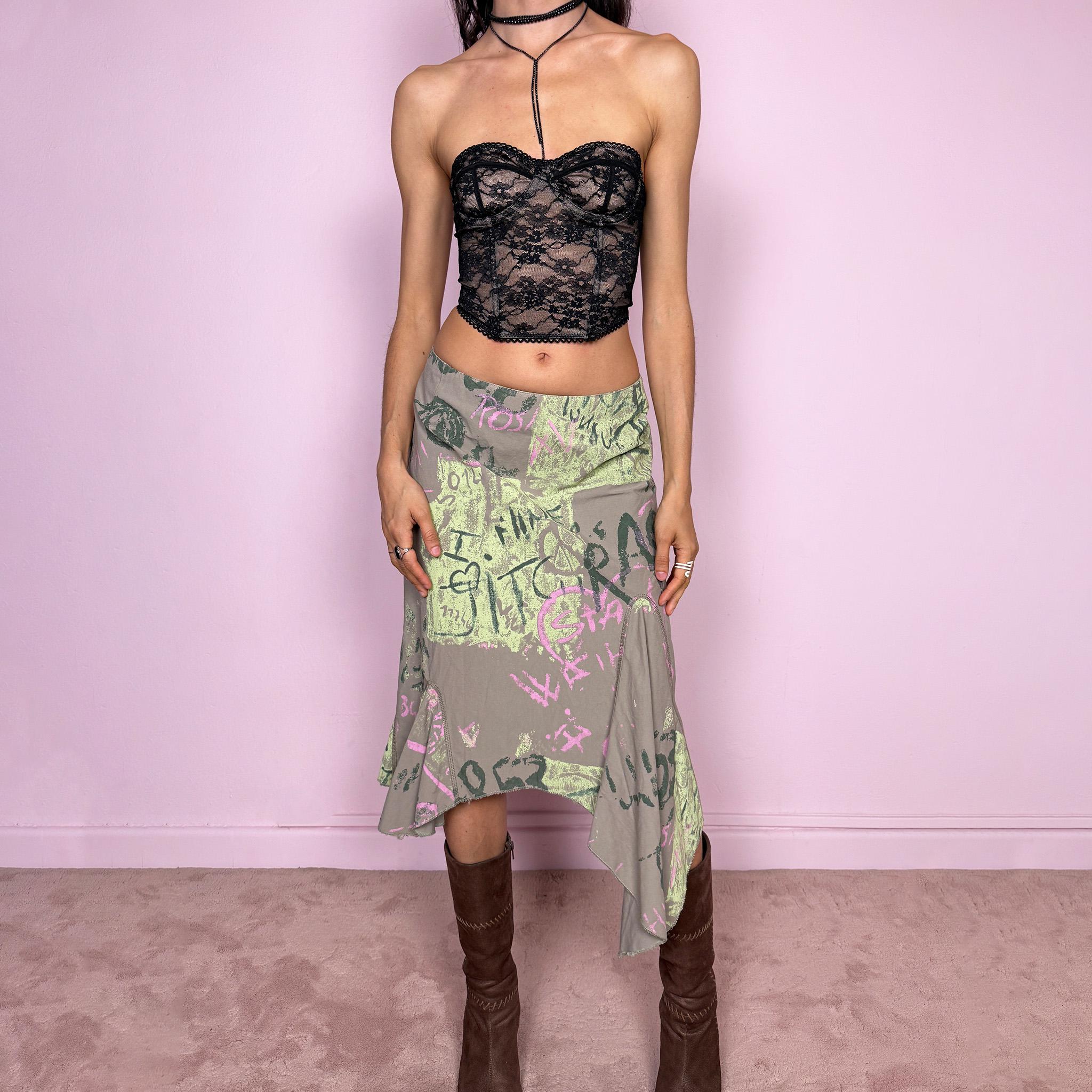 Vintage 2000s deconstructed avant garde midi skirt in green with an abstract graphic print and asymmetric hem. Features a layered draped panel design and back zip closure, no stretch. Can be worn high waisted for size M or mid to low rise for XS/S. Made in France from a 55% polyamide and 45% cotton blend. Great vintage condition.