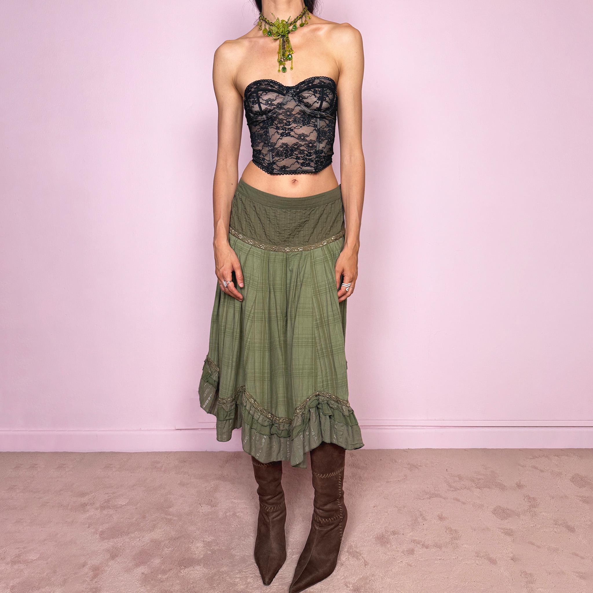 Vintage 2000s olive green khaki midi skirt with a soft bohemian feel, featuring a gathered silhouette, pleated waist panel, and layered ruffle hem with floral embroidered trim details. Designed in non-stretch 100% cotton fabric with a side zip closure, the skirt has a romantic, earthy look. Can be worn mid-rise for size L. Great vintage condition.