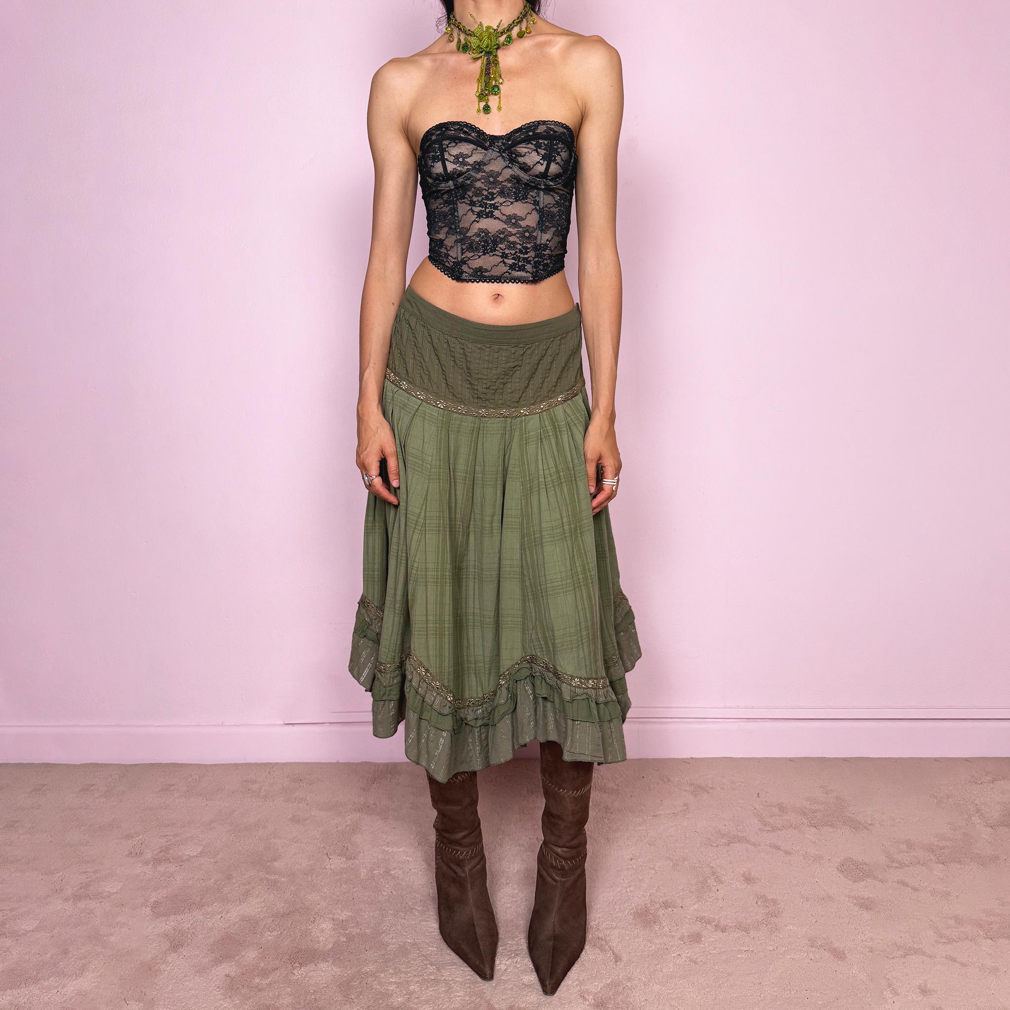 Vintage 2000s olive green khaki midi skirt with a soft bohemian feel, featuring a gathered silhouette, pleated waist panel, and layered ruffle hem with floral embroidered trim details. Designed in non-stretch 100% cotton fabric with a side zip closure, the skirt has a romantic, earthy look. Can be worn mid-rise for size L. Great vintage condition.