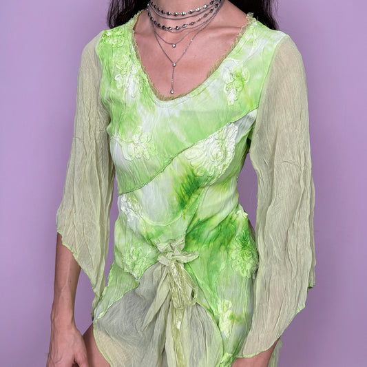 Stunning fairycore vintage 2000s top in many shades of green with a tie dye effect. Features 3/4 bell sleeves, applique details, a draped tie-front design, and an asymmetric pointy hem. Unique flowy silhouette with a bohemian pixie feel, ideal for summer or spring events and festivals. Slightly stretchy fabric. Excellent vintage condition.