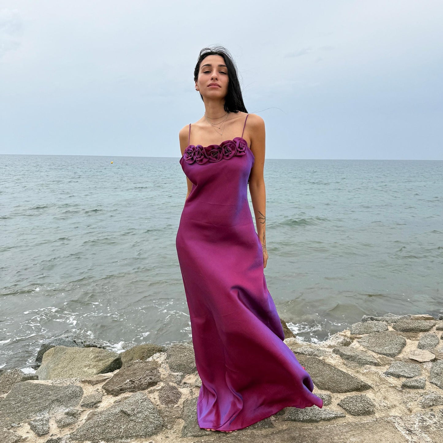 Vintage Y2K iridescent slip midi dress from the 2000s in a stunning maroon tone with blueish undertones that shift toward purple depending on light reflection. Features a sculptural rosette appliqué along the bust and spaghetti straps. The shimmering surface enhances its red carpet appeal, making it ideal for proms, summer weddings, gala events, or romantic evenings. Made in France from a non-stretch polyester viscose blend fabric. Great vintage condition.