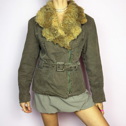 The Y2K Khaki Belted Jacket is a vintage 2000s piece featuring a structured fit with rugged utility-inspired details. Designed with padded shoulders for a strong silhouette, an oversized plush faux-shearling collar, asymmetric zip closure, and an adjustable waist belt for a cinched look. The washed khaki tone and distressed finish add to its edgy, worn-in appeal, making it perfect for grunge or military-inspired winter outfits. A bold outerwear piece for layering in colder seasons.