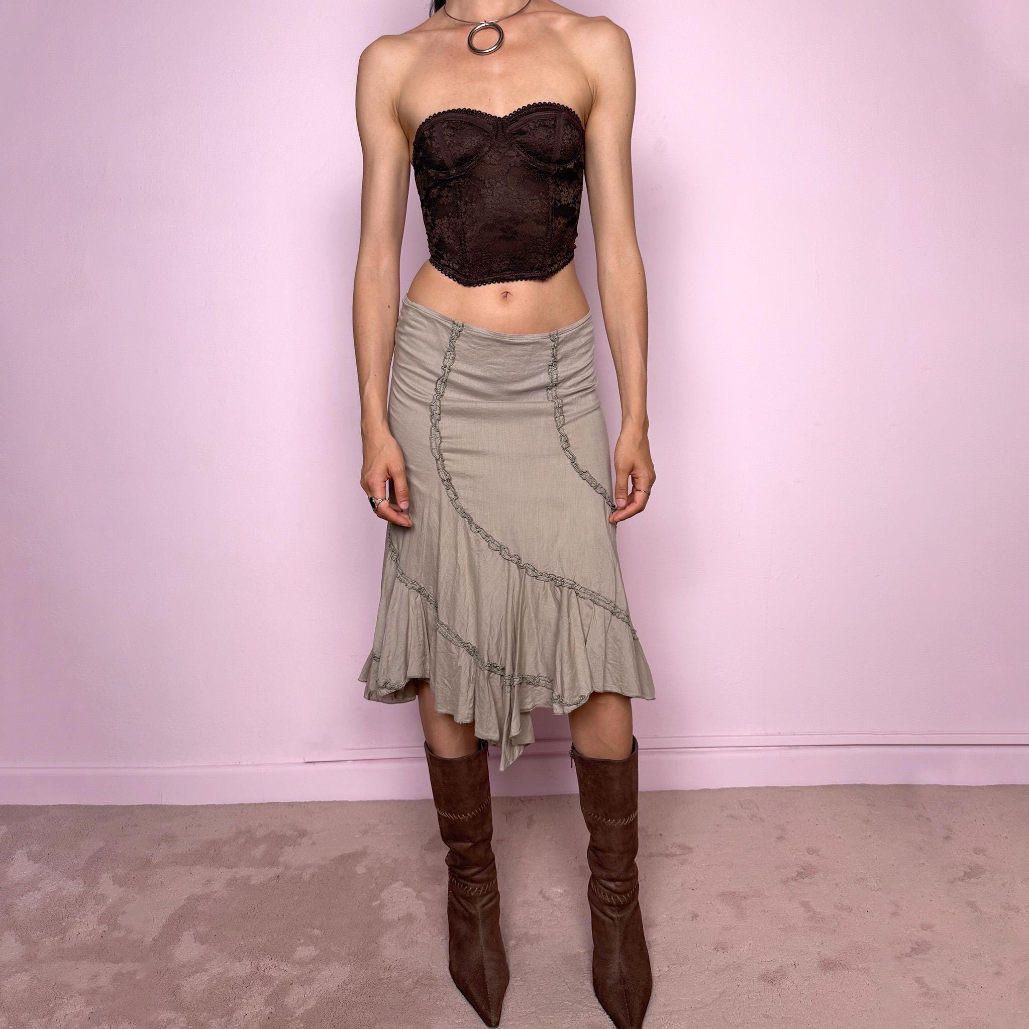 Vintage 2000s light khaki green asymmetric midi skirt made from 100% cotton. Features a side zip closure, no stretch, soft draped panels, and delicate ruffle trim detailing throughout the front and hem. A romantic Y2K bohemian piece in a muted taupe-khaki tone, perfect for fairy summer looks. Can be worn mid-rise for size S or lower rise for XS. Excellent vintage condition.