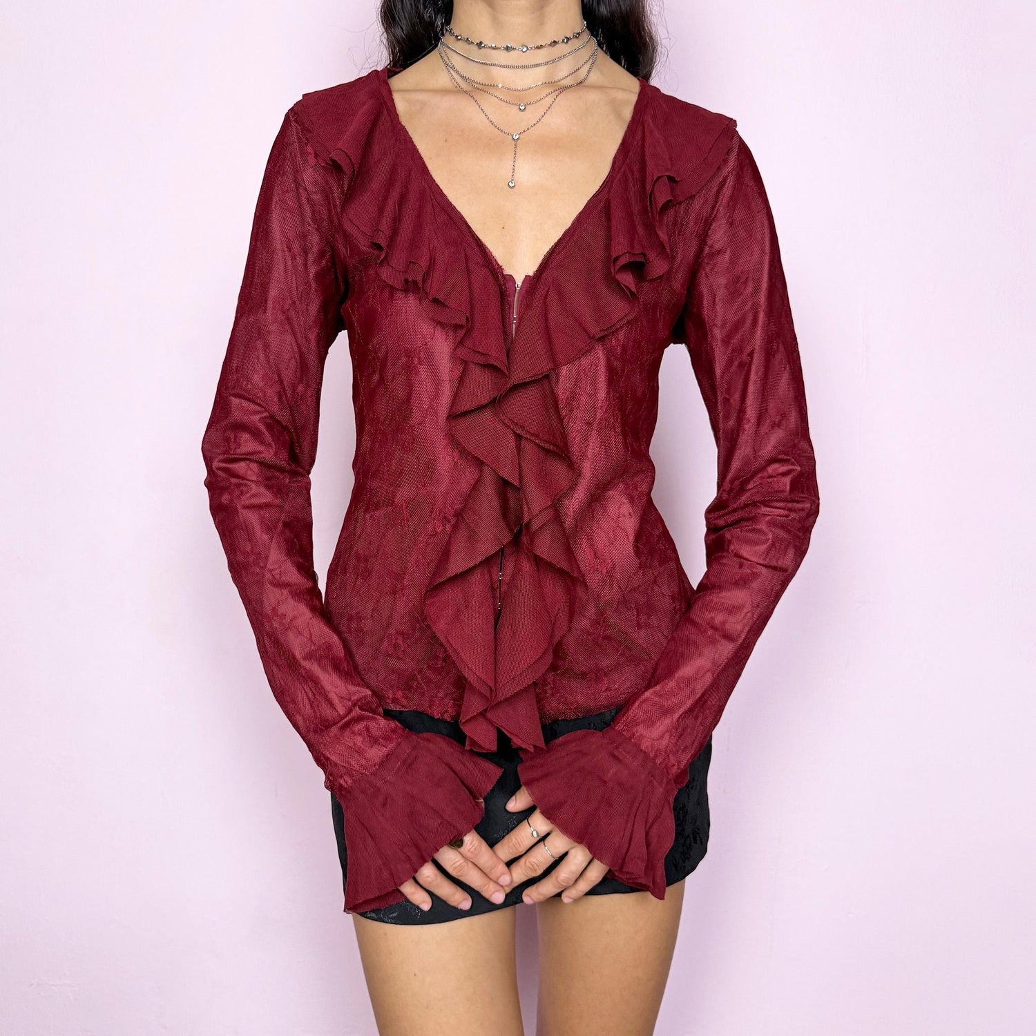 Romantic vintage 2000s maroon burgundy lace top featuring long bell sleeves with ruffle cuffs, ruffled V neckline, and front hook closure. Whimsical fairy-inspired style for night outings, parties, or elegant formal styling. Non-stretch fabric. Excellent vintage condition.
