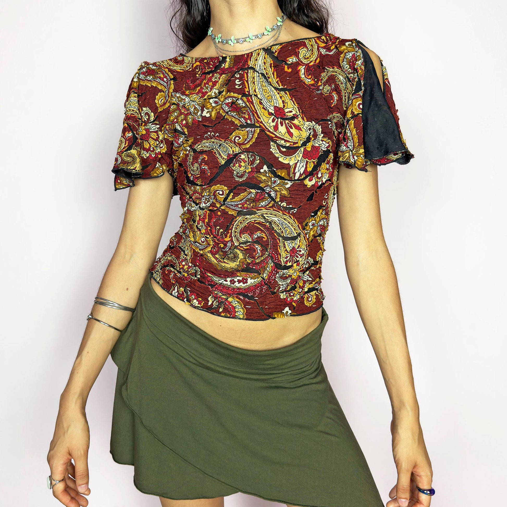 This vintage 2000s crinkle mesh top stuns with yellow-gold paisley prints on a rich maroon base and a dramatic split short sleeve. Ideal for summer nights, art parties, or elegant outdoor dinner looks. A rare, textile-rich piece with gypsy-bohemian undertones and free-spirited dancing energy. Made of stretch polyester blend. Great vintage condition.