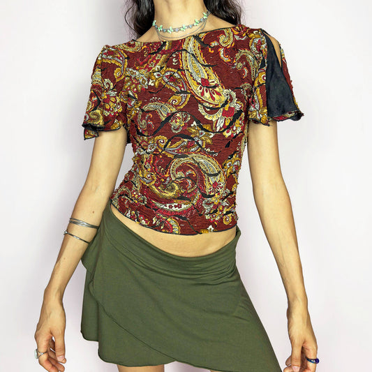 This vintage 2000s crinkle mesh top stuns with yellow-gold paisley prints on a rich maroon base and a dramatic split short sleeve. Ideal for summer nights, art parties, or elegant outdoor dinner looks. A rare, textile-rich piece with gypsy-bohemian undertones and free-spirited dancing energy. Made of stretch polyester blend. Great vintage condition.