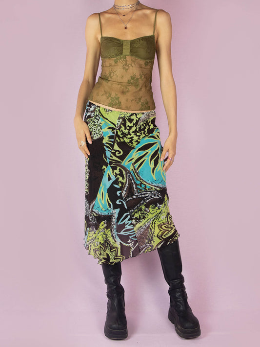 This vintage 2000s mesh midi skirt features a bold tropical abstract print in vibrant lime, turquoise, and brown tones. Designed with an asymmetric hem, semi-sheer fabric, and a soft elastic waistband, it can be styled low-rise for a true Y2K silhouette. Lightweight and fluid, it’s ideal for summer parties, beach nights, or layered vacation looks. A sheer, expressive piece that captures the playful spirit of the era.