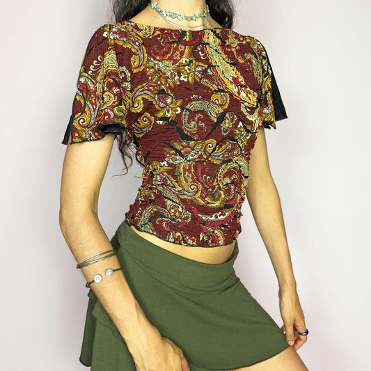 This vintage 2000s crinkle mesh top stuns with yellow-gold paisley prints on a rich maroon base and a dramatic split short sleeve. Ideal for summer nights, art parties, or elegant outdoor dinner looks. A rare, textile-rich piece with gypsy-bohemian undertones and free-spirited dancing energy. Made of stretch polyester blend. Great vintage condition.