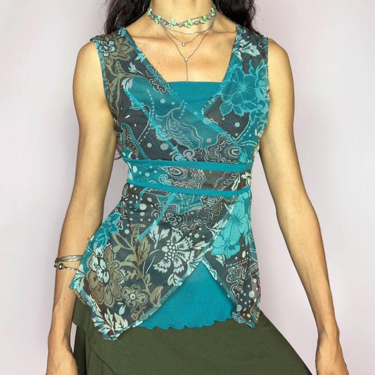 This vintage 2000s bohemian mermaidcore teal mesh wrap top blooms with layered floral motifs and boho swirls in sheer brown, beige, and aqua tones. The sleeveless silhouette features contrast piping and an asymmetric hem. Perfect for summer parties, festival layering, or vacation styling. A striking Y2K piece with romantic texture and carefree energy. Made of stretch polyester mesh. Excellent vintage condition.