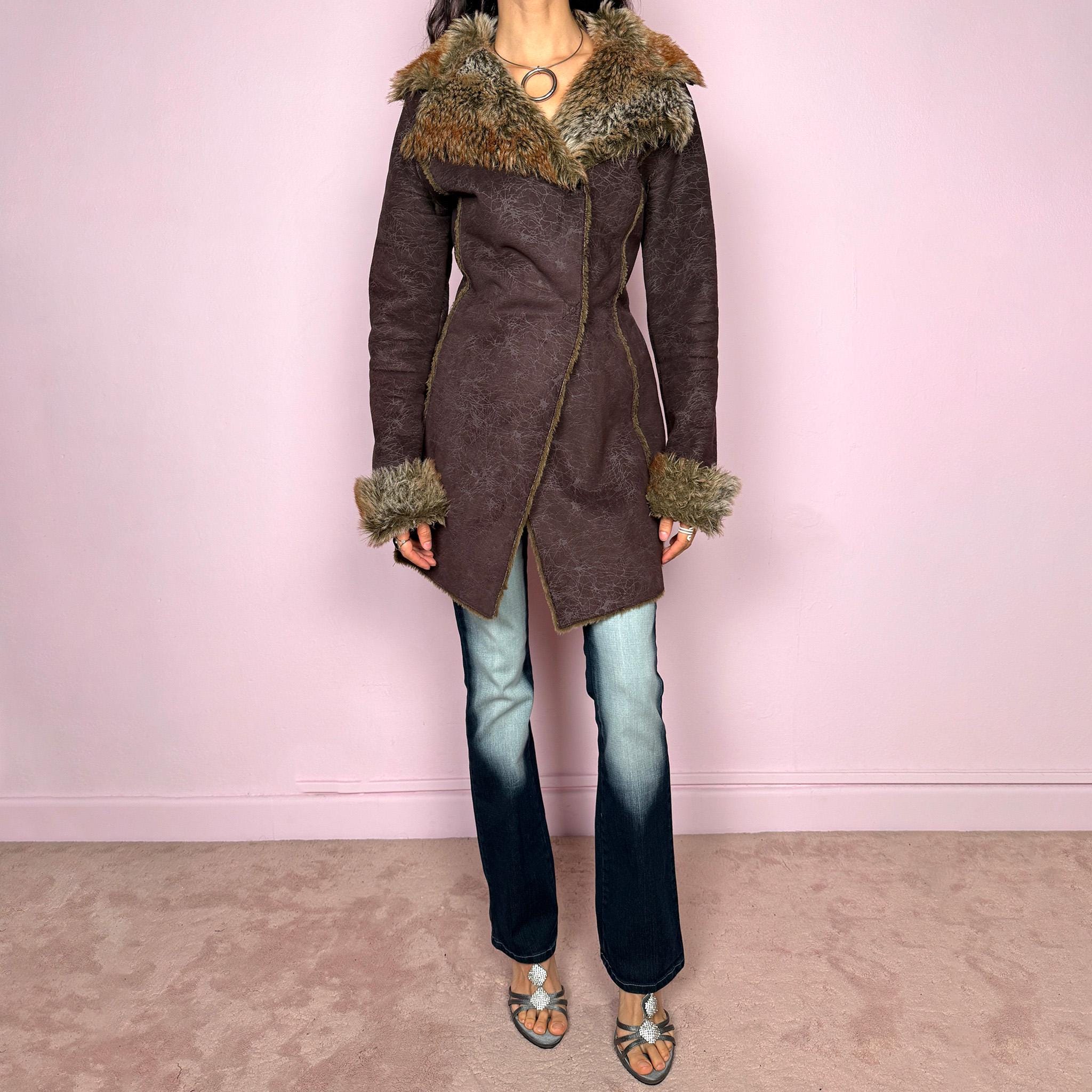 Vintage 2000s brown long coat in a statement penny lane style with a fitted silhouette. Features snap button closure, matching fabric belt, and plush brown and beige faux fur lining at the collar and cuffs. Perfect for city girl winter and Y2K styling. Made from a polyester acrylic blend. Excellent vintage condition.