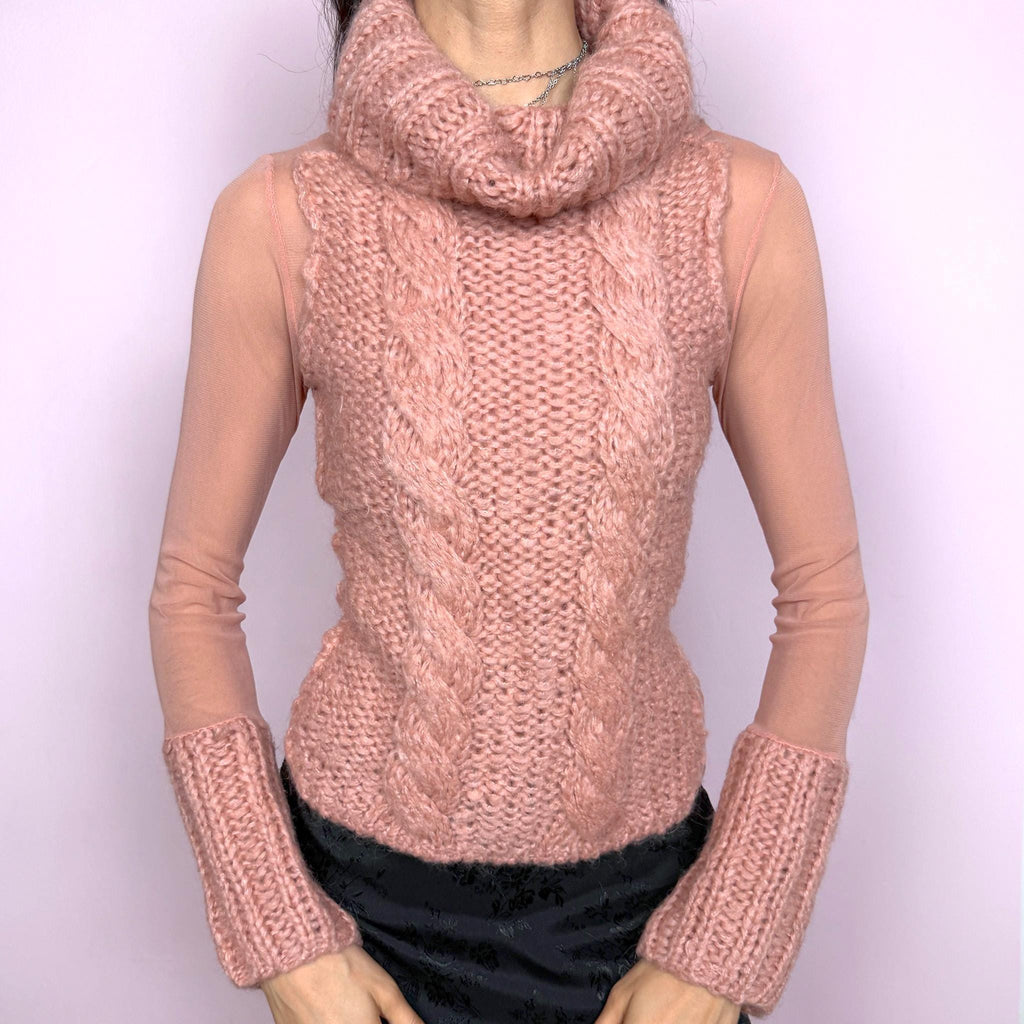 Vintage 2000s avant garde bi-material pink top with a turtleneck, cuffs, and cable knit front crafted from 40% mohair, 30% wool, and 20% acrylic, combined with semi sheer mesh polyamide panels. Stretchy with a fitted silhouette, blending soft coquette aesthetics with a unique deconstructed design. Made in Italy. Excellent vintage condition.