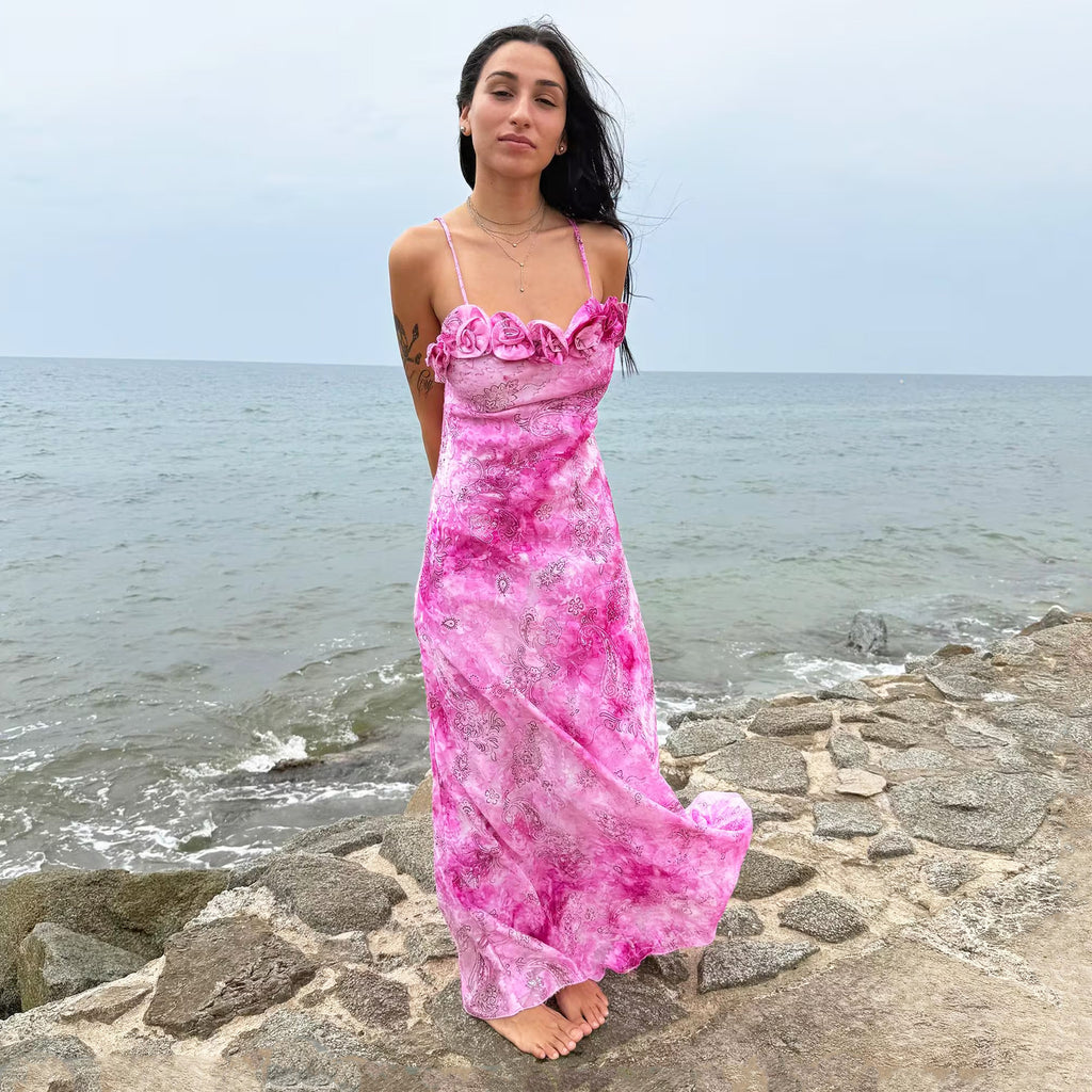 Vintage 2000s slip dress with a vivid pink tie-dye paisley print, rosette appliqué neckline, and long flowing silhouette. Comes with a matching scarf for versatile styling, ideal for summer weddings, proms, formal parties, bridal, evening, or statement occasions. Made in France from a non-stretch polyester blend. Excellent vintage condition.