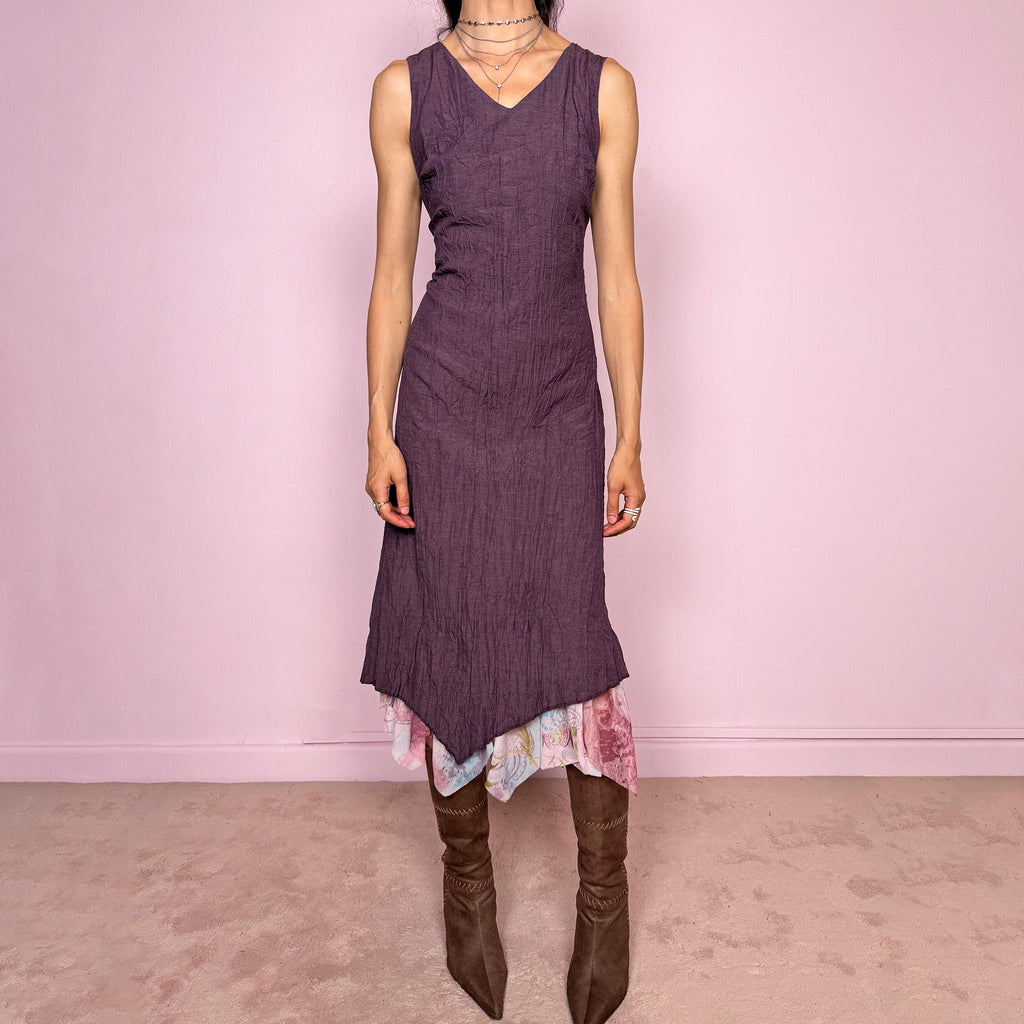 Vintage 2000s purple sleeveless midi dress with a minimal avant-garde look, no stretch, V-neckline, crinkle texture, flowy fit, side zip closure, and an asymmetric hem with graphic print mesh ruffle detail. Made by a French brand from a polyester viscose blend. Great vintage condition.
