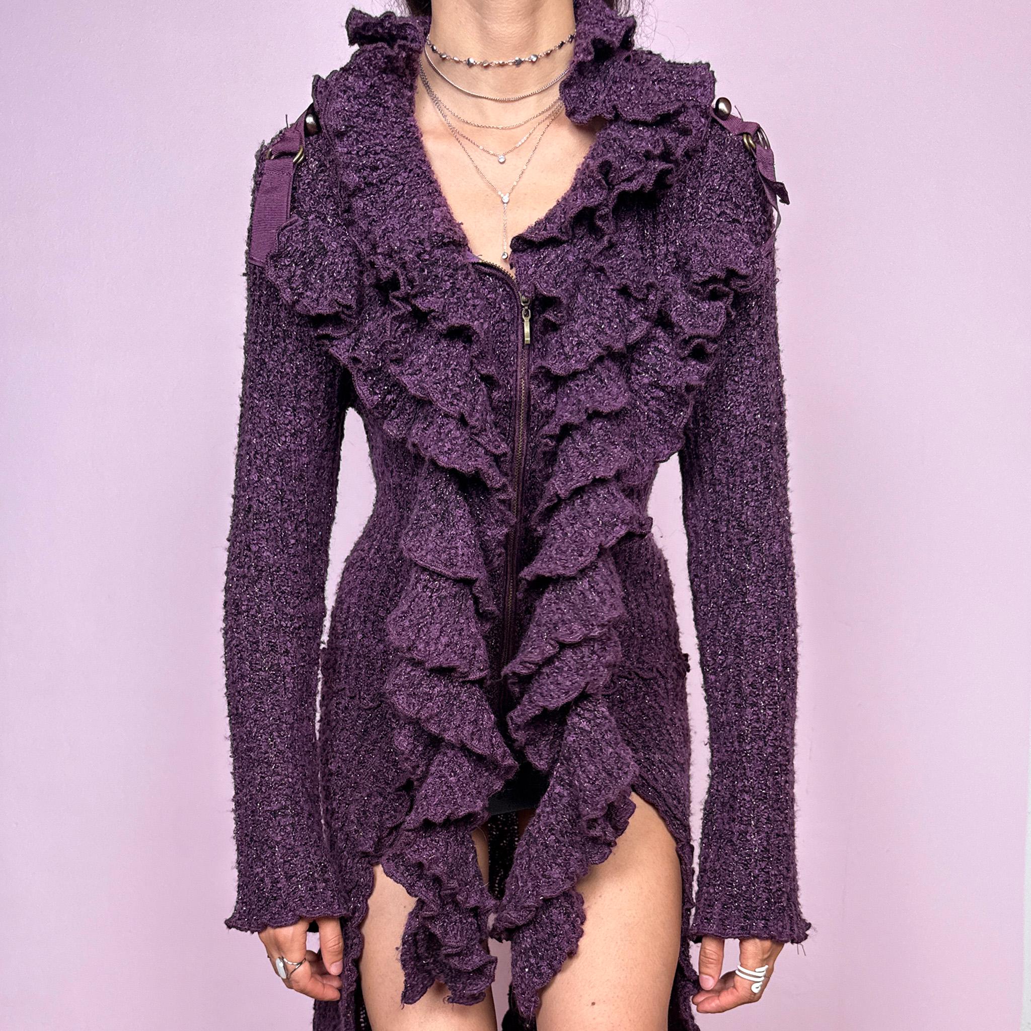 Vintage 2000s purple and black longline crazy cardigan with metallic thread, a zip-front closure, long bell sleeves, sculptural ruffle neckline, 3D cascading front ruffles, and an asymmetric high-low hem. Dramatic, extravagant, and bold for winter. Made by a French brand from an acrylic polyester blend. Great vintage condition.